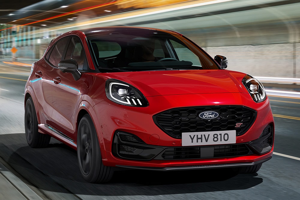 Red new Ford Puma ST driving front view